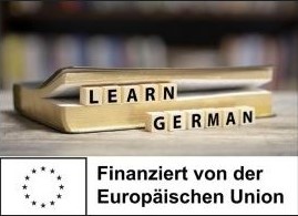 Buchstabenwürfel mit "Lern German" vor einem Buch